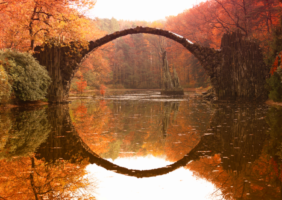 Bridge reflecting in waterway below to create the illusion of a circle.